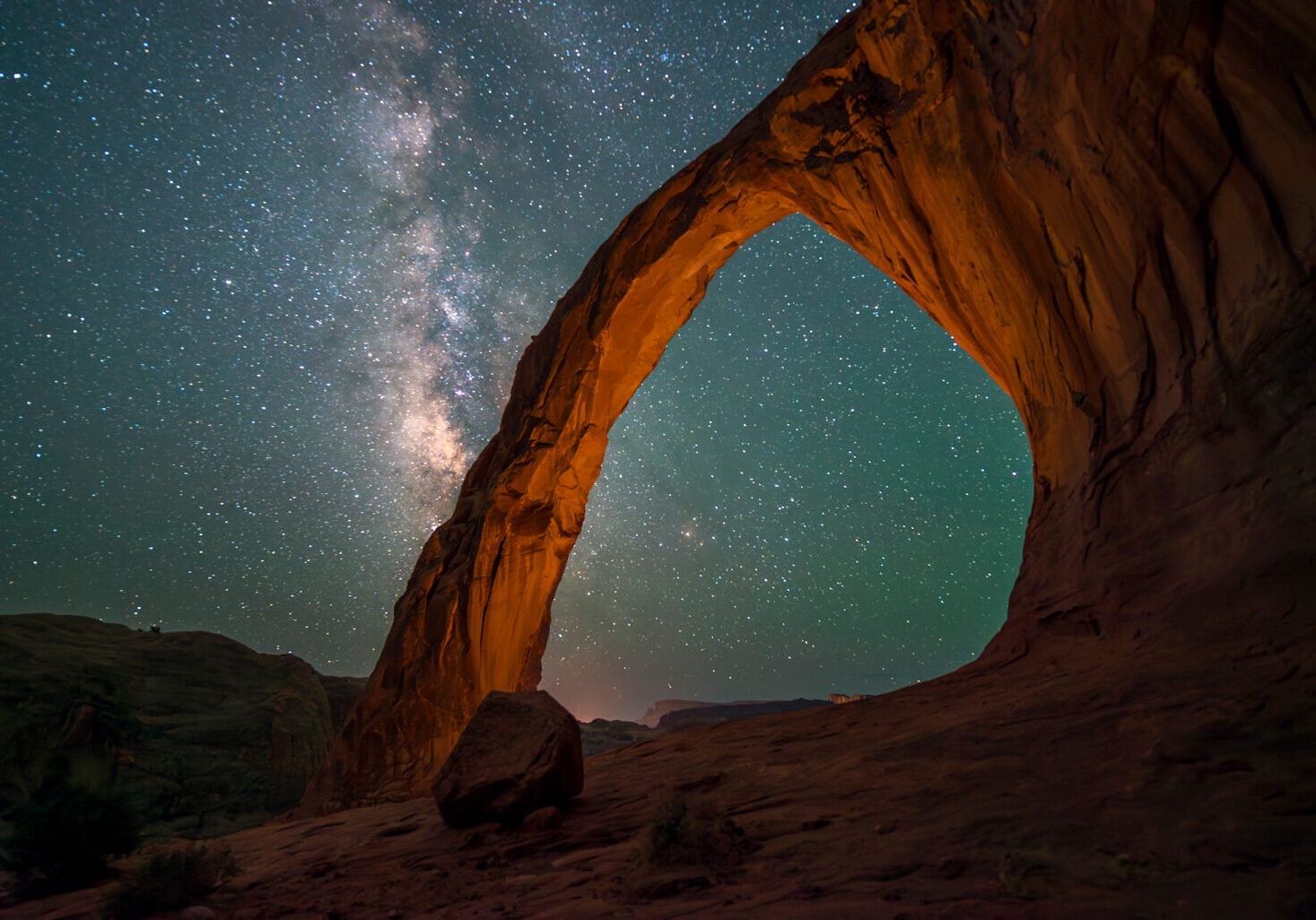 Star filled sky in the shadow of the Corona Arch, also known as Little Rainbow Bridge, near Moab, Utah.